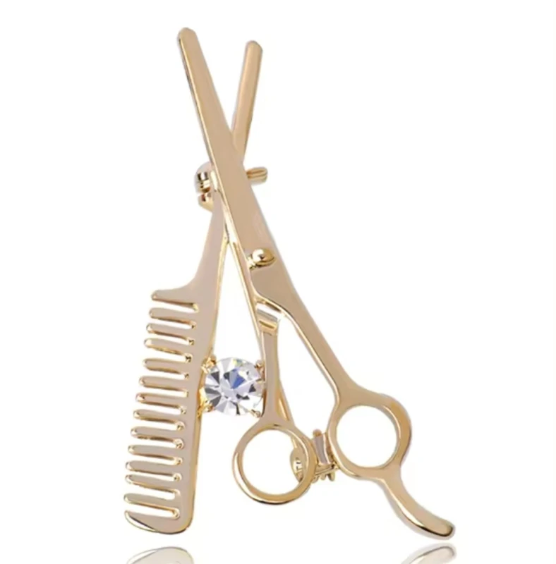 Zelta piespraude ar šķērēm un dekoratīvu friziera ķemmi